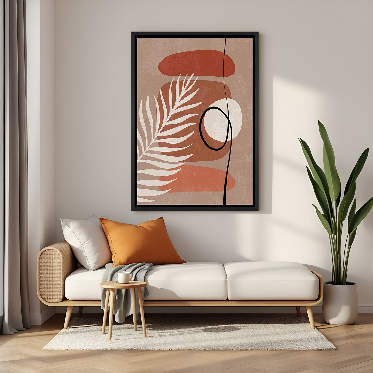 Black framed wall art featuring random shapes and leaf stem in earthy boho tones and minimal layout