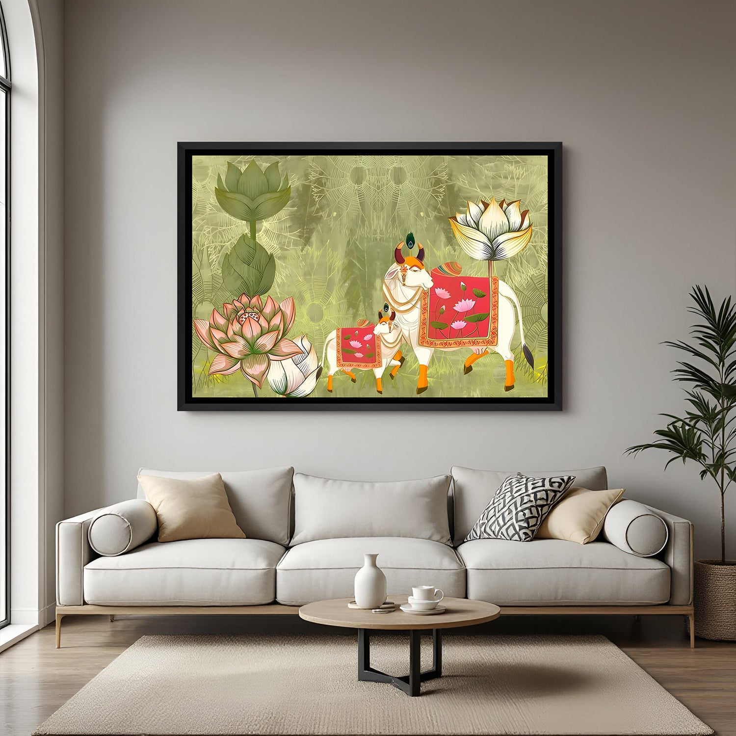 Pichwai Kamadhenu artwork with pink decorative textiles and lotus flowers in elegant black floater frame