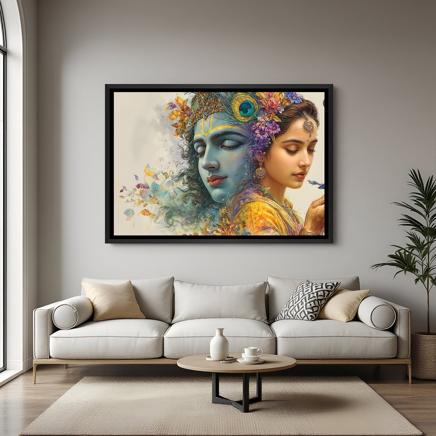 Radha Krishna framed wall art displayed above modern sofa in blush interior.