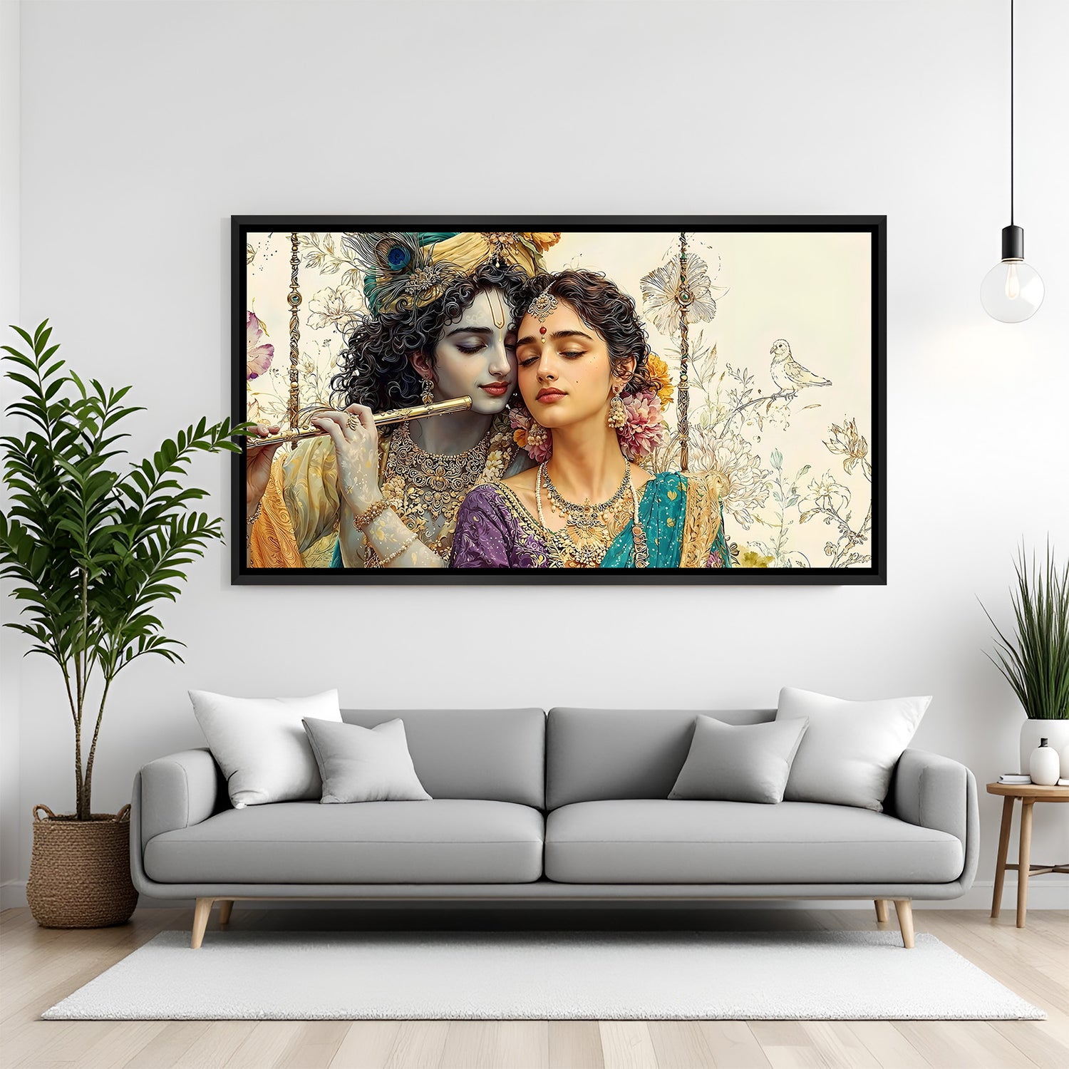 Radha Krishna panoramic artwork in black frame displayed above modern sofa.