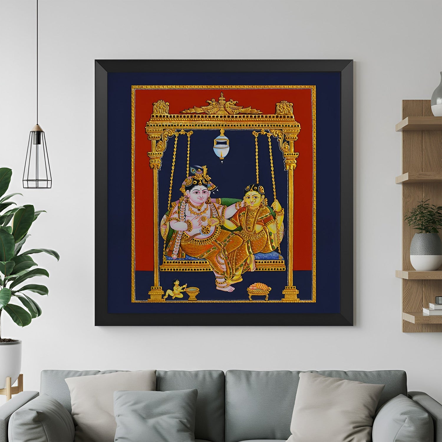 Black frame Tanjore painting of Radha Krishna seated on wooden jhula for devotional home decor and Vastu-inspired Indian interiors