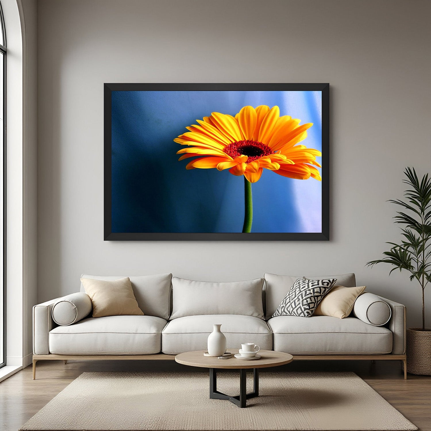 Framed canvas print of a sunflower with blue background and black floater frame, ideal for modern and minimal spaces