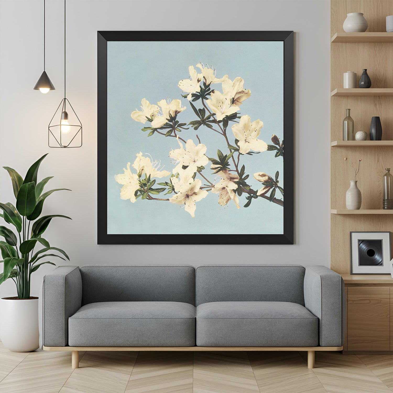 Framed canvas print of delicate white blossoms on a thin branch with black floater frame, ideal for minimalist and modern interiors