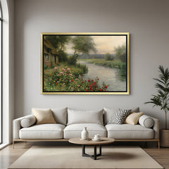 Golden-framed vintage wall art of landscape with house, river, greenery, and blooming flowers—aged canvas look