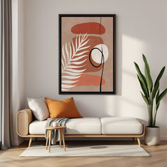 Black framed wall art featuring random shapes and leaf stem in earthy boho tones and minimal layout