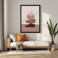 Black framed boho canvas with different shaped pebbles stacked in neutral tones on soft backdrop