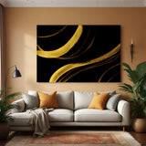 Black and gold abstract brush stroke canvas wall art with flowing metallic strokes in modern living room