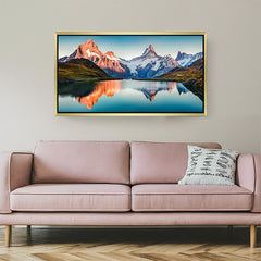 Tranquil canvas print of calm water with distorted mountain reflection, displayed in golden floater frame for elegant nature-inspired interiors