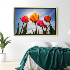 Golden-framed canvas wall art featuring multi-colored tulips from a low angle, great for lively and creative wall decoration