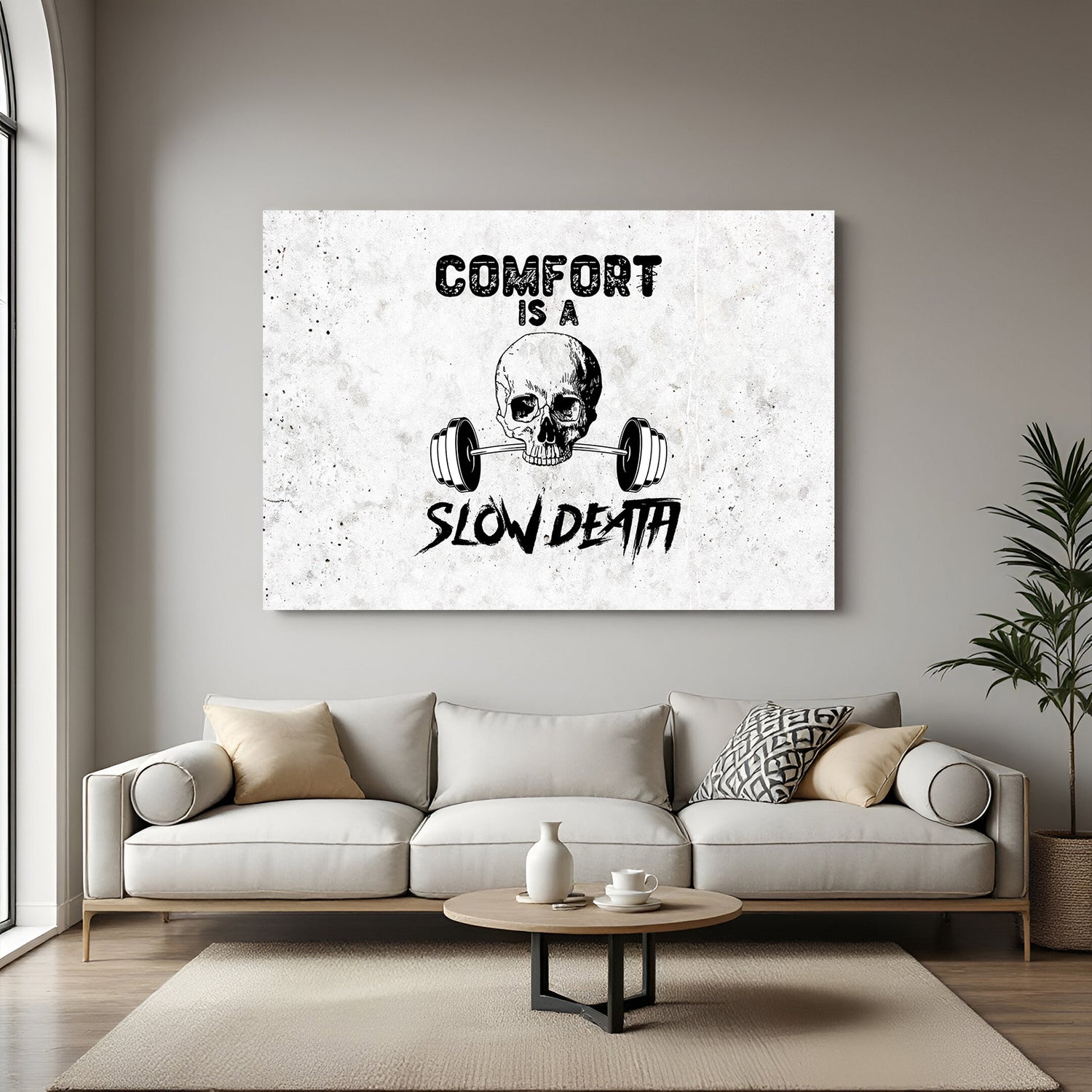 Canvas wall art with white background, skull in center, and bold quote: Comfort is a Slow Death