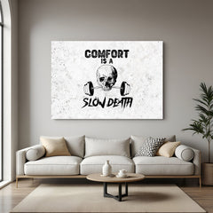 Canvas wall art with white background, skull in center, and bold quote: Comfort is a Slow Death