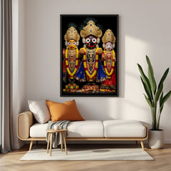 Jagannath Balabhadra Subhadra portrait displayed in black floater frame with rich garlands and ornate temple jewelry.