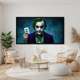 Joker holding playing card wall art in black floater frame with dramatic lighting and villain theme
