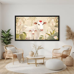 Sacred Kamdhenu and calf lotus wall art in black frame displayed on teal accent wall.