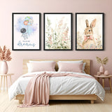 Set of 3 kids canvas wall art prints with astronaut flying holding planet balloons, floral grass illustration, and a cute rabbit – ideal for nursery decor