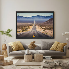 Endless desert road painting with dry terrain on either side, framed in black floater for modern and minimal interior wall styling