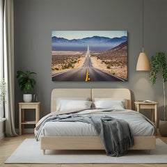 Canvas wall art showing a long road vanishing into the horizon, with desert landscape on both sides, creating a bold and open travel-inspired decor look