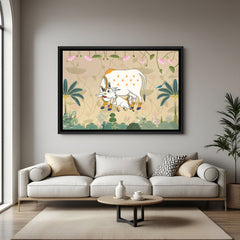 Traditional Kamadhenu Pichwai painting with lotus motifs in elegant black floater frame