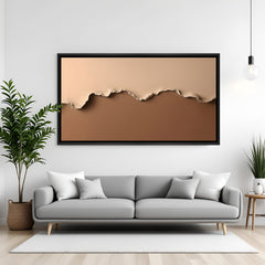 Neutral abstract canvas wall art with layered paper effect in beige and brown tones with black floater frame above sofa in contemporary living room decor