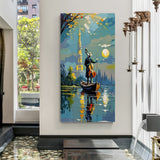 Vertical musician canal wall art in canvas wrapped frame featuring a cello player standing in a boat under a glowing moon with city reflections.