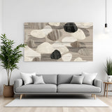 Neutral abstract canvas wall art in beige and grey tones with pebble texture design, displayed above a sofa in a modern living room with canvas wrapped finish