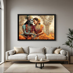 Framed Radha Krishna wall art displayed above beige sofa in warm interior.