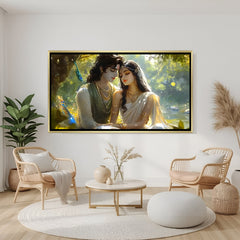 Elegant Radha Krishna wall art in gold frame featuring romantic forest background and peacock feather detail.