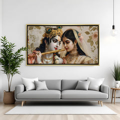 Luxury Radha Krishna wall art in gold frame featuring flute, floral backdrop, and traditional detailing.