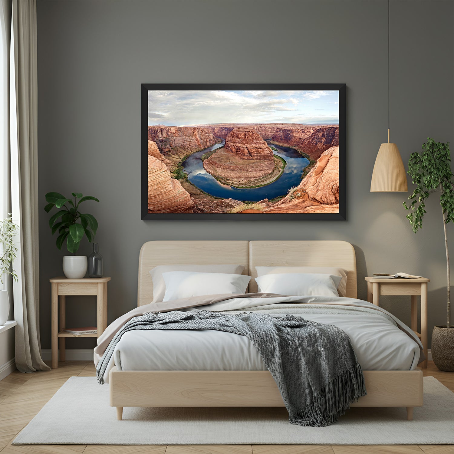Valley painting with red rock hills and water body around a central hill, displayed in black floater frame for bold and earthy interior styling