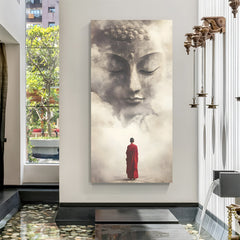 Vertical spiritual wall art featuring monk in red robe beneath misty Buddha face.