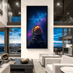 Space-themed motivational painting in black floater frame – astronaut in helmet gazing at butterfly with Stay Focused quote