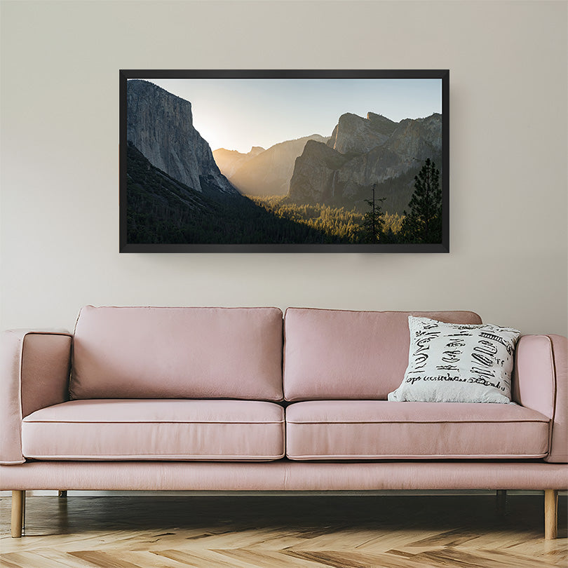 Morning sunrise painting with sunlight shining across rolling hills, framed in a black floater frame for elegant and uplifting wall styling