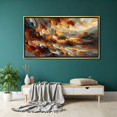 Textured abstract canvas wall art in warm brown and orange tones with golden floater frame displayed in elegant modern living room decor
