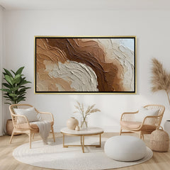Textured neutral abstract canvas wall art in warm brown and beige tones with golden floater frame in elegant modern living room decor