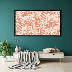 Coral botanical abstract canvas wall art with white leaf pattern in black floater frame above sofa in contemporary living room decor