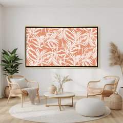 Tropical leaf pattern canvas wall art in coral and white tones with golden floater frame displayed in elegant modern living room decor