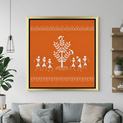 Golden frame Warli tribal art canvas painting featuring symbolic Indian folk figures and traditional design