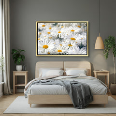 Golden framed wall art of white daisy flowers in a green field, designed for elegant, nature-inspired interior decoration